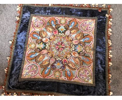 An 1870/80's vintage cloth, which has a heavily hand embroidered centre in a rich embroidered and in a rainbow of colours, in