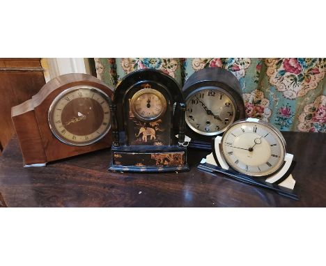 An Anglo Indian style mantle clock, with a silvered&nbsp;dial, black Roman numerals, paper covered and&nbsp;papier mache case