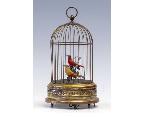 An early 20th Century brass bird cage musical automaton, with a pair of birds on a branch, key wind mechanism, height 28cmCON