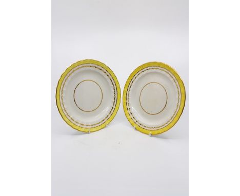 Two Derby twist fluted edge plates with a yellow band and gilt borders, Exhibition label on reverse, puce mark circa 1872-180