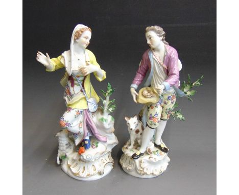 A pair of Meissen figures of a shepherd and shepherdess, he standing hold a birds nest in his hat and a basket of eggs in his