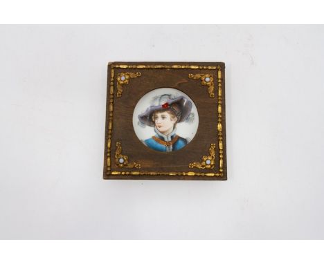 A porcelain hand painted miniature portrait, having a wooden surround and gilt mounts. Size 10.5cm.square. Condition: Some we