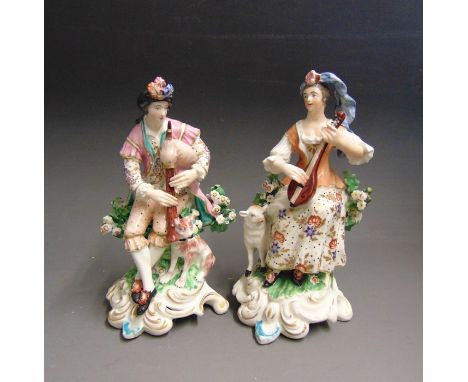 A pair of Derby figures of  seated musicians, he with a dog and she with a sheep, incised No.301, circa 1775, 20cm high (2)Co