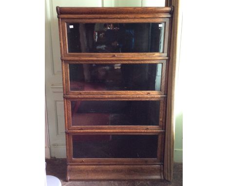 An early 20th Century four tier oak stacking bookcase, possibly by Globe Wernicke, each section having a glazed door opening 