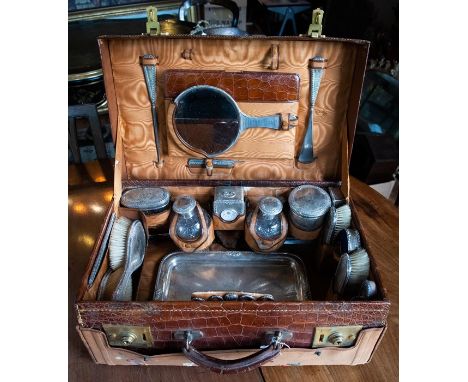 A George V leather fitted travelling case, the interior&nbsp;featuring twenty-three silver and leather&nbsp;accouchements to 