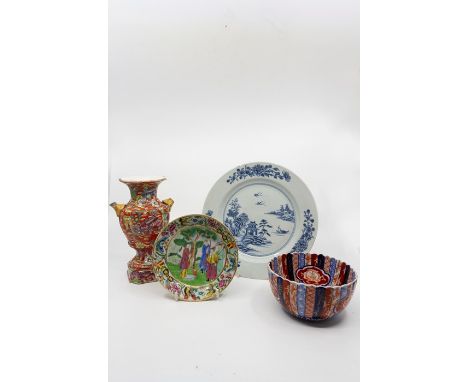 A famille rose saucer with border of flowers and butterflies, central scene with four figures, diameter 14 cms, a loved Imari