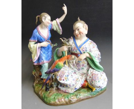 A very large Meissen pagoda figural group, the Chinese man sitting holding a stick with a dragon on the top, a colourful parr