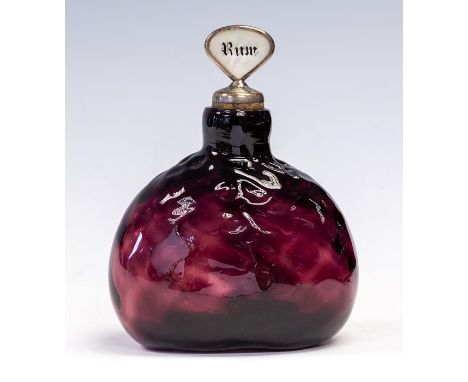 A 19th Century amethyst glass decanter, dimple body, broken pontil base, with two mother of pearl stoppers, one Rum, the othe
