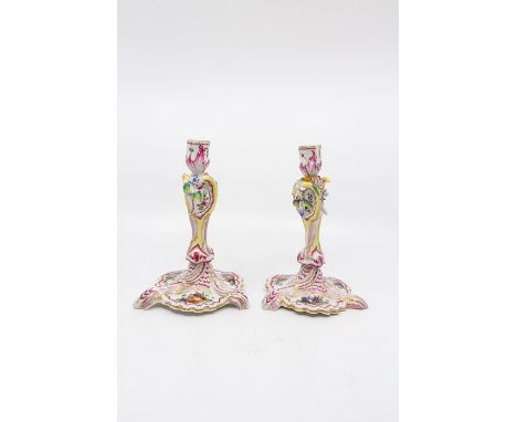 A pair of Berlin candlesticks hand painted with Watteau style scenes. Circa mid 19th centurySize 19.5cm. high.Condition; Scon