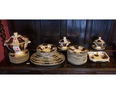 A 19th century Derby red mark part dinner service, decorated with blue ground gilt panels between plain scroll and Billingsle
