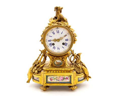 A 19th Century French gilt ormolu bracket clock, circa 1870, of Baroque design with a dog with game finial, 10cm circular whi