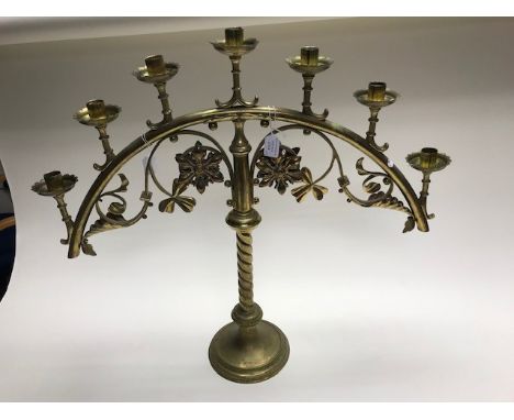 A pair of late 19th Century brass ecclesiastical seven light candelabra, attributed to John Hardman Powell, the sconces mount