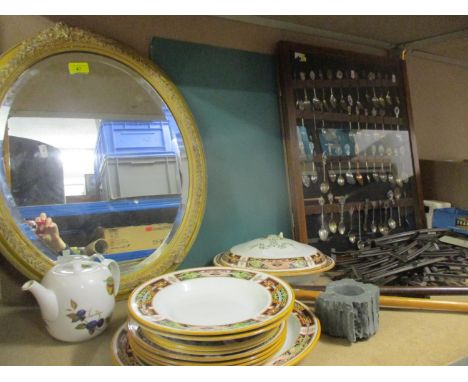 A mixed lot to include a display case of collectors spoons, vintage trainset track, a gilt oval mirror, walking sticks and mi