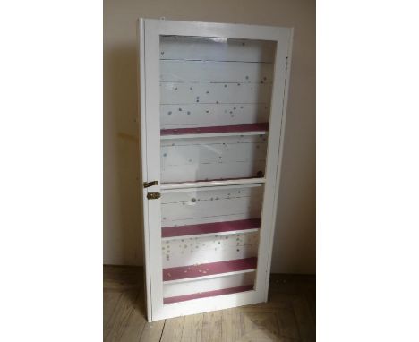 Early 20th C painted shelf unit enclosed by a single glazed cupboard door (69cm x 17cm x 149cm) 