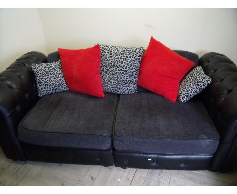 Modern black leather and upholstered part Chesterfield type two seat sofa with loose scatter cushions 