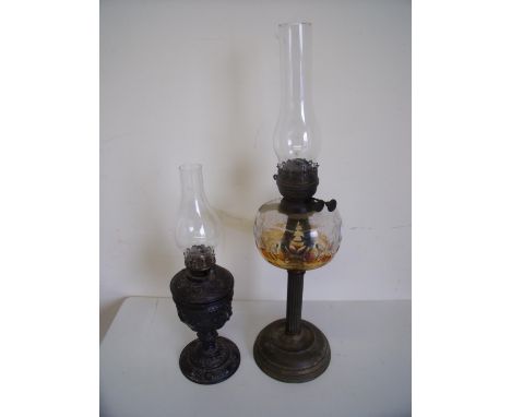 Late Victorian oil lamp with clear glass reservoir and another with embossed spelter type body (2) 