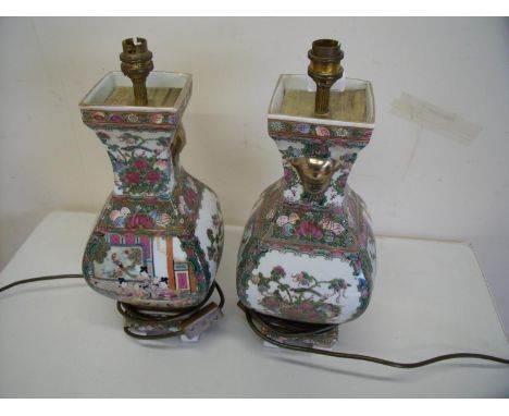 Pair of oriental ceramic table lamps of square bulbous form on raised bases (height 40cm) 