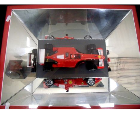 Framed and mounted mirrored display of a Formula 1 Ferrari model racing car (56cm x 44cm) 