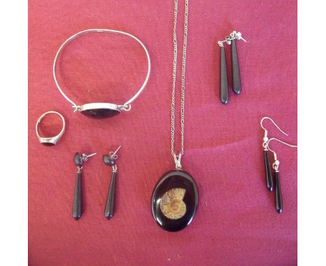 Collection of Whitby Jet jewellery including earrings, silver mounted bracelet, signet style ring and pendant set with ammoni