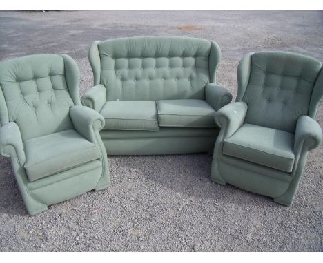 Three piece suite comprising of two seat sofa and a pair of matching armchairs 