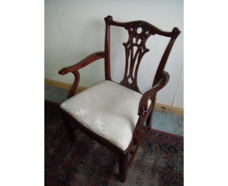 Set of six (4 + 2) Chippendale style mahogany dining chairs with broad drop in silk work seats and carved detail 