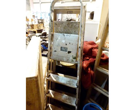 Two sets of metal step ladders 