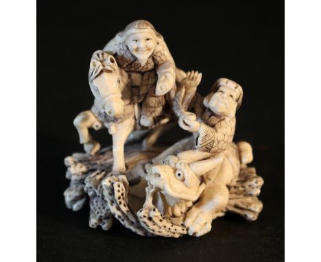Asian ivory Netsuke a horse rider and a man on a dragon;  on the under side two holes for mounting, richly carved and partly 