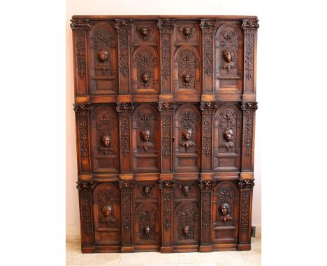 Hugues Sambin (1520-1601)-attributed, Two richly carved oak doors with faces and angels' heads, in arched niches surrounded b