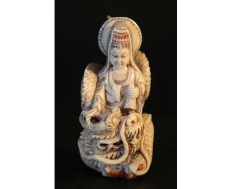 Ivory Netsuke showing Guanyin on a dragon; very fine carving; partly engraved and coloured; with open work; on the bottom sig