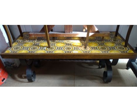 A rectangular tile-top coffee table on wrought-iron base, W111cm 