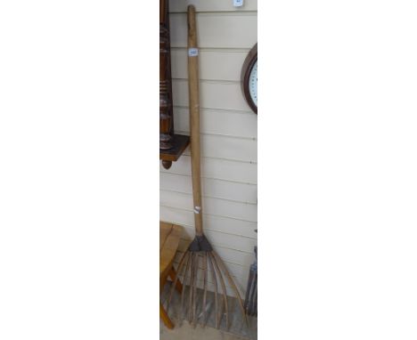 A rustic folk art leather-bound garden fork 