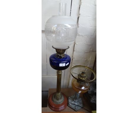A Duplex brass and Bristol blue glass oil lamp, with etched glass shade, height excluding chimney 28", together with an amber
