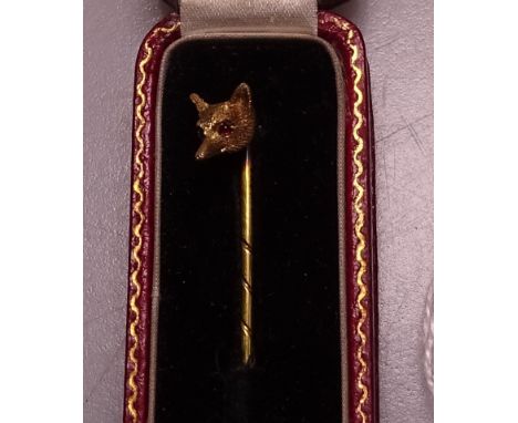 An unmarked gold foxhead stickpin, set with amethyst eyes, original box 