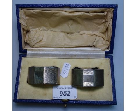 A pair of engine turned silver napkin rings, in original box 