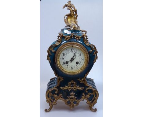 A 19th century French blue-glaze ceramic-cased mantel clock, with ornate gilt-metal mounts, ornate enamel dial, and 8-day str