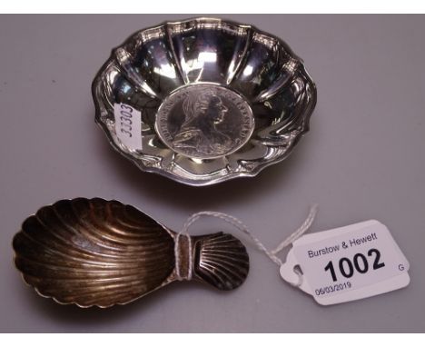 A silver caddy spoon, and a Continental silver dish, inset with a 1780 Maria Theresa Thaler coin 