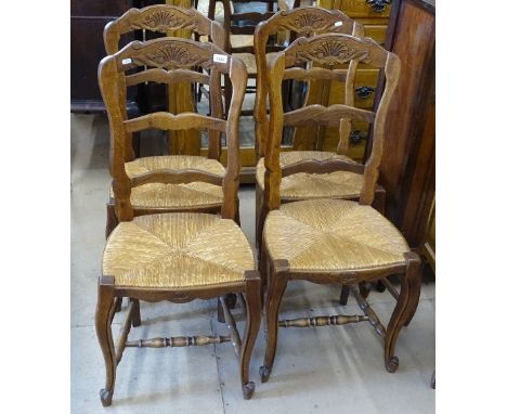 A set of 4 French carved oak ladder-back dining chairs, with rush seats 