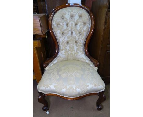 A Victorian mahogany-framed and button-backed upholstered nursing chair 