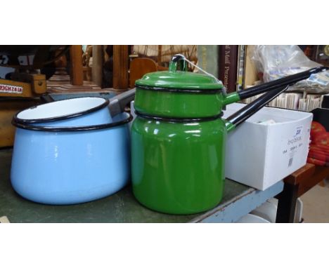 A group of coloured enamel cooking pans 