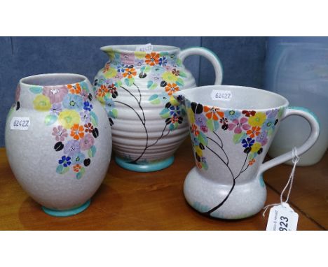 A Carlton Ware ribbed jug with painted floral design, height 6.5", matching vase and jug, in spring/coffee bean pattern. 