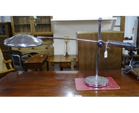 An unusual chrome desk lamp, with a chrome Mercedes Benz hub cap shade 