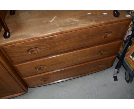 An Ercol mid or light stain low chest of three drawers