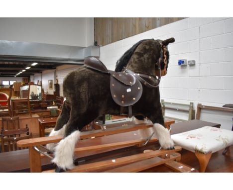 A vintage plush rocking horse, missing stirrups