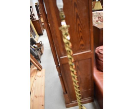 A vintage brass standard lamp having twist column