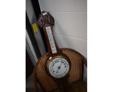 An early 20th Century oak cased aneroid barometer