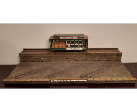 Vintage Japanese tin plate model of a San Francisco Cable Car No. 512 and a Corgi British Tram Collection display stand