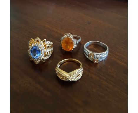 Four silver and silver gilt paste set rings, various sizes