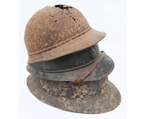 A WWI French Adrian pattern steel helmet: with attached comb and flaming grenade badge (no liner) together with two battlefie