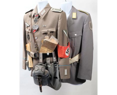A reproduction German army tunic, decorated with badges, shoulder flashes and equipment: including a wound badge, Iron Cross 