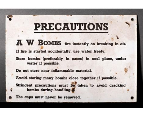 A WWII enamel sign 'Precautions A W Bombs': black text on white ground, 20.5 x 30.5cm (2)